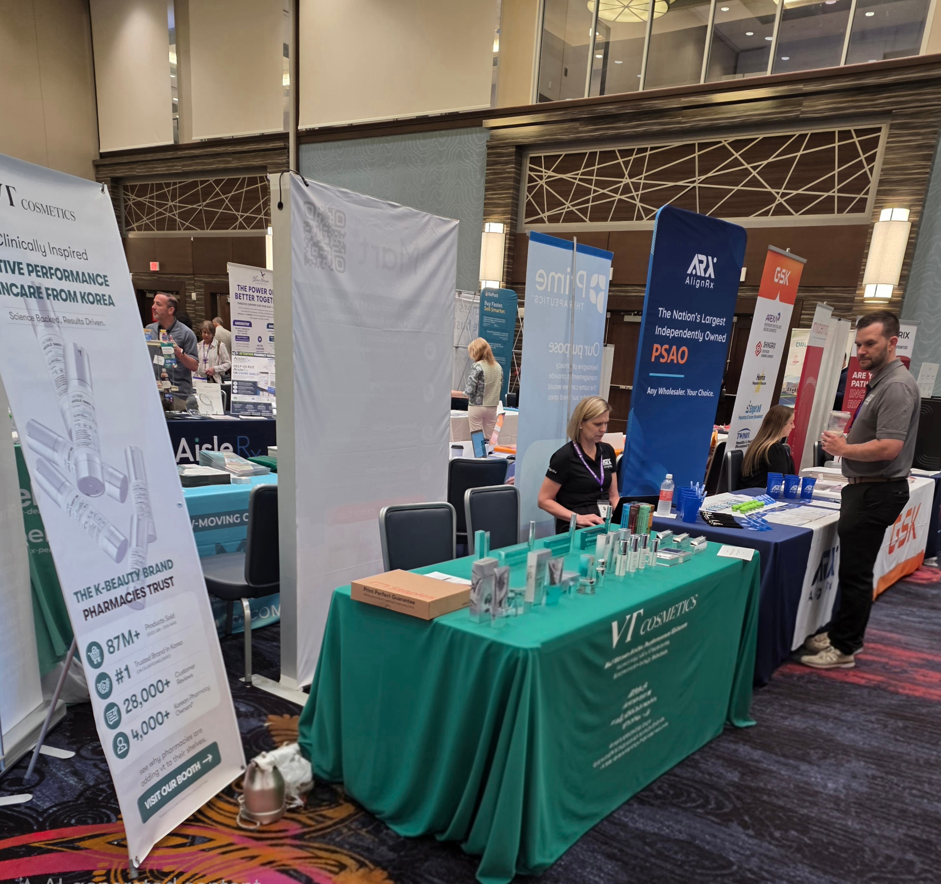 VT Cosmetics booth with green tablecloth, skincare products and banners at the PSSNY annual convention